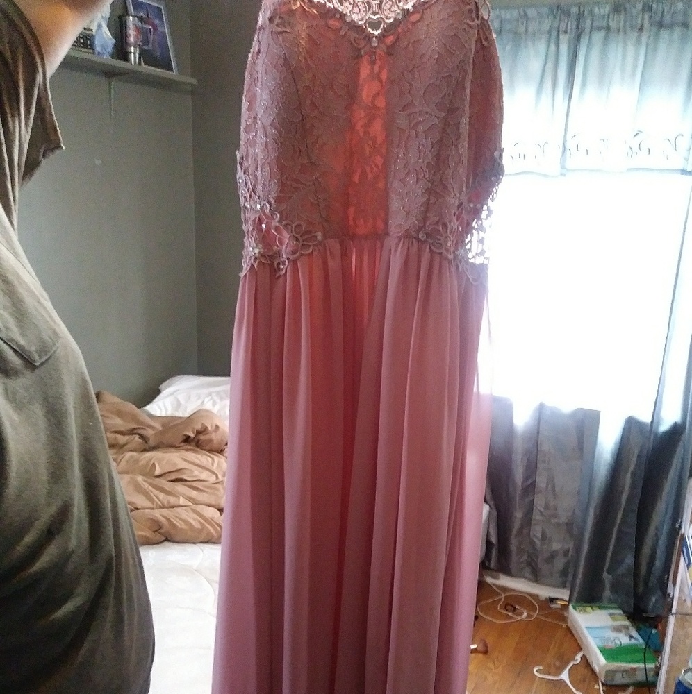 A peachy colored prom dress